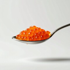 A spoonful of vibrant orange salmon caviar on display