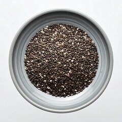 Chia seeds in a gray ceramic bowl on white background