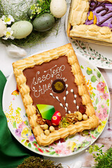 Traditional Polish Easter pastry Mazurek on an Easter background.top veiw