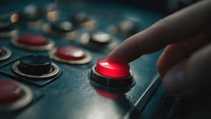 Finger pressing a red button