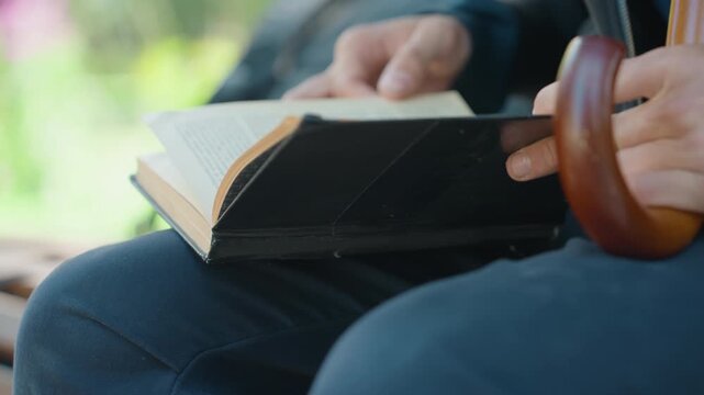 retired teacher reading memoir on garden bench, hands flipping pages near curved wooden cane handle, warm bokeh background, intimate closeup of worn binding and focused fingers, nostalgic mood
