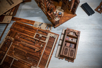 Detailed miniature wooden library interior with spiral staircase, bookshelves and tiny furniture....