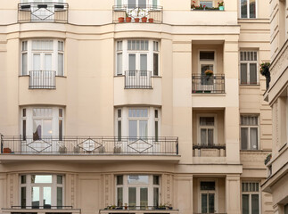 Fototapeta premium Facade of a residential building with symmetrical balconies and windows in European style