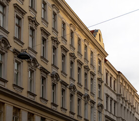 Fototapeta premium A row of old residential buildings in a European city with classic architecture and evening lighting