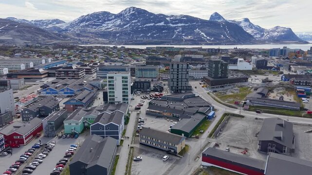 GREENLAND - 11.4.2025 - Beautiful aerial footage moving towards snowy mountains in Nuuk, Greenland.