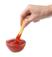 Woman dipping tasty French fry into ketchup against white background, closeup