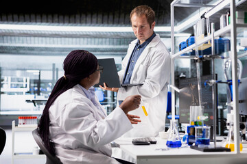 Modern lab workspace with diverse scientists working on biotechnology research. Collaboration highlighting genetics, molecular science and clinical diagnostics for innovation in healthcare.