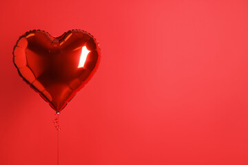 Heart-shaped balloon on red background, space for text. Valentine's Day
