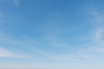Blue sky with wispy clouds stretches over a calm horizon, presenting an expansive outdoor scene filled with serenity, light and natural air, ideal for nature, travel and minimalistic branding. © SHOTPRIME STUDIO