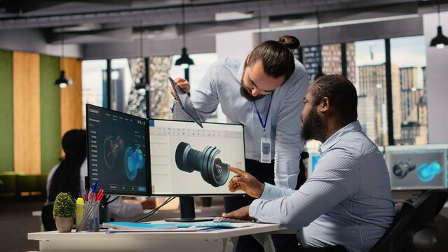 Team of technicians working together to upgrade turbine parts to maximize sustainability. Colleagues doing brainstorming to refine blade aerodynamics, boosting green energy output, camera B