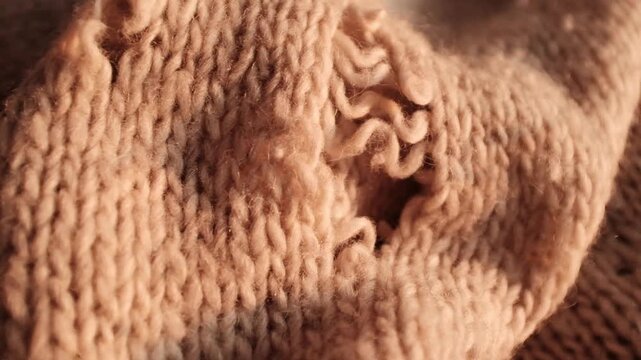Closeup video of hands touching soft knitted wool sweater with a hole in it. Damaged torn knitted handmade sweater. Appreciating pleasant texture of high quality textile for clothes. Soft and cozy tex