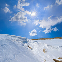 mountain in the snow under a sparkle sun