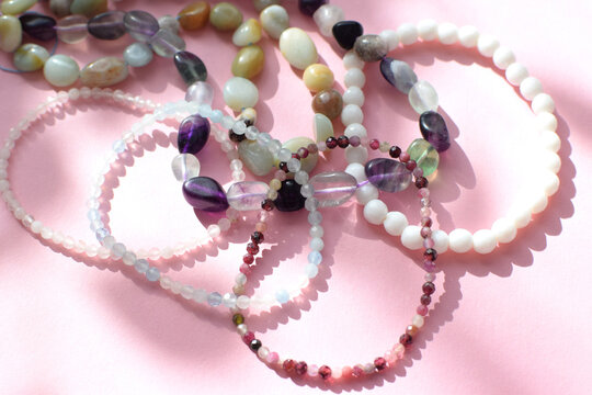 Beads and bracelets made of natural stones: rose quartz, fluorite, garnet, tourmaline and aquamarine