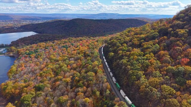 PENNSYLVANIA - 11.10.2025 - Incredible aerial footage following a freight train traveling on Pennsylvania's Horseshoe Curve, surrounded by autumn trees.