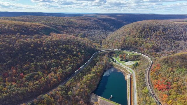 PENNSYLVANIA - 11.10.2025 - Stunning aerial footage of a freight train traveling on Pennsylvania's Horseshoe Curve, surrounded by autumn trees.