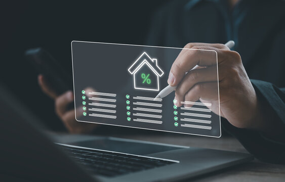 Business professional reviewing digital mortgage and loan checklist with virtual home and percentage icons, representing interest rates, property finance, real estate planning, and modern financial te