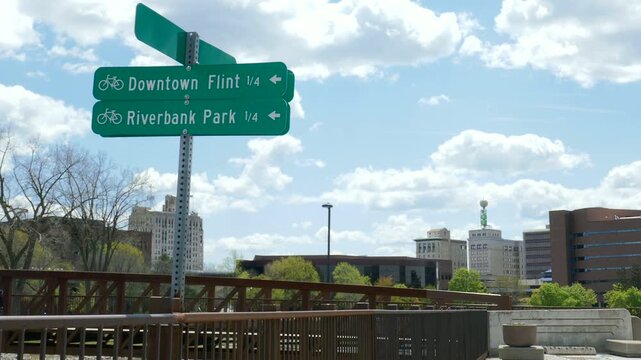 Downtown Flint and Riverbank Park bicycle path direction signs along the Flint River in Flint, Michigan.