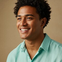 A radiant young man with a bright smile and curly hair, dressed in a calming teal shirt.