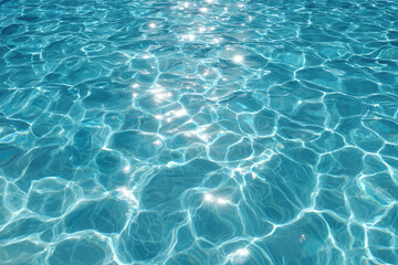 Obraz premium clear blue water with sunlight reflections on the surface.