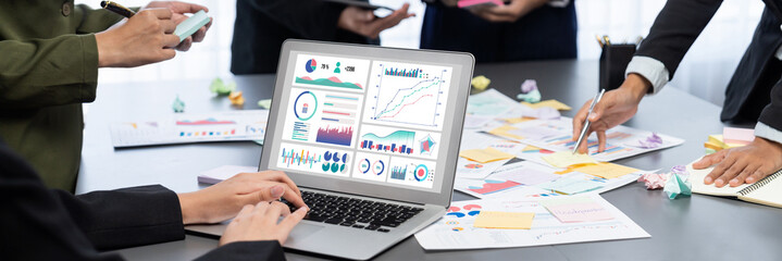 Analyst team use sticky note for creative and analytic brainstorm for business idea with BI data dashboard on laptop screen. Analysis financial data visualization tech for marketing strategy. Prodigy