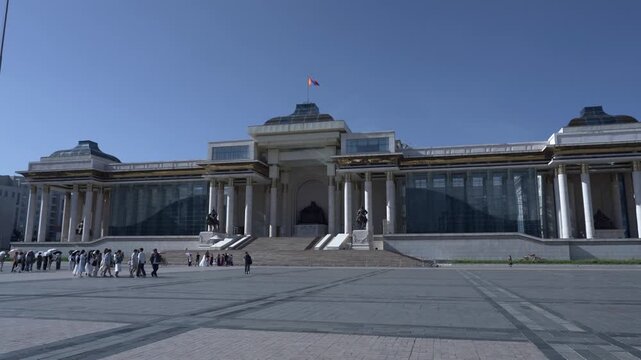 Ulaanbaatar, Mongolia - 08 09 2024: Sukhbaatar Square Facing the Government Palace in Summer. People and tourists walking through the square.