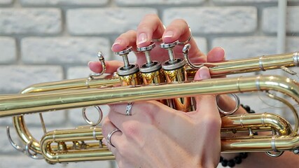 golden trumpet valves close-up: musician's skillful hand movement | music, performance, art, skill, close-up theme