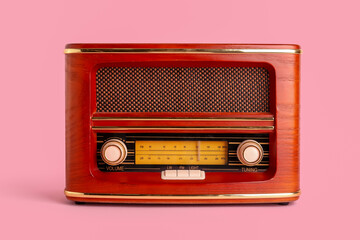 Vintage radio receiver on pink background