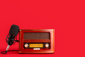 Vintage radio receiver with microphone on red background
