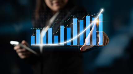 A businesswoman interacts with a digital financial graph while analyzing data on her smartphone. The scene symbolizes growth forecasts and technological innovation. Impute
