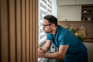 Stressed healthcare worker experiencing burnout and exhaustion looking away
