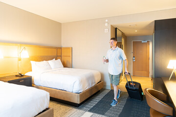 Traveler arrives in hotel room for stay