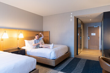 Hotel guest relaxing in the room while enjoying entertainment