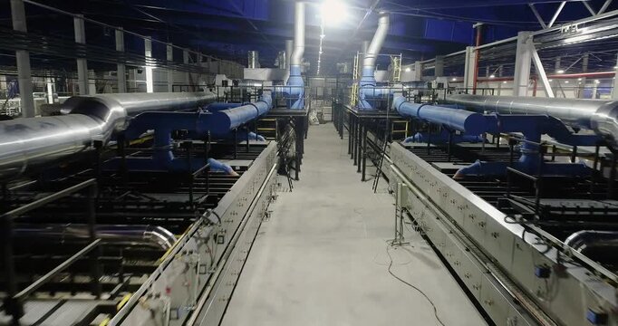 Ceramic Tile Roller Kiln. A production line or conveyor at a ceramic and porcelain tile factory. Firing. Ceramic Tile Making. Roller Kiln for the Production of Ceramic Tiles.