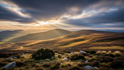 Spectacular sunbeams breaking through dramatic clouds over rolling hills and moorland at sunset
