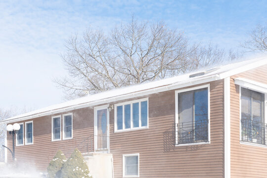 snow in the wind after blizzard around residential house