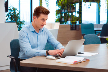 Businessman working on a laptop in a modern office