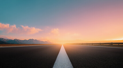 Empty highway road stretching towards colorful sunset sky