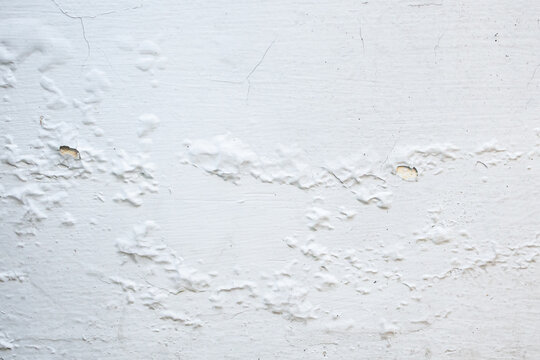 Peeling and Bubbling White Paint on Concrete Wall Texture Background