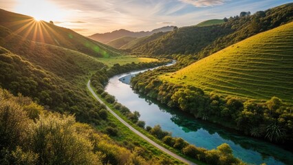Serene landscape with winding river through green hills at sunset