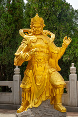 Fototapeta premium Genre sculpture at the foot of the Great Buddha Statue in the picturesque Nanshan area of the Jiaodong Peninsula