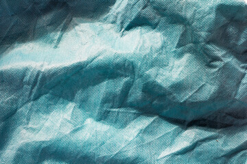 Abstract creases in white and blue fabric.