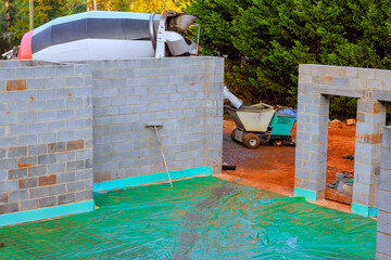 Construction activity shows cement mixer pouring concrete at building site
