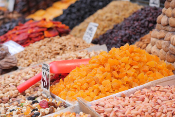 Colorful display of dried fruits and nuts in a market