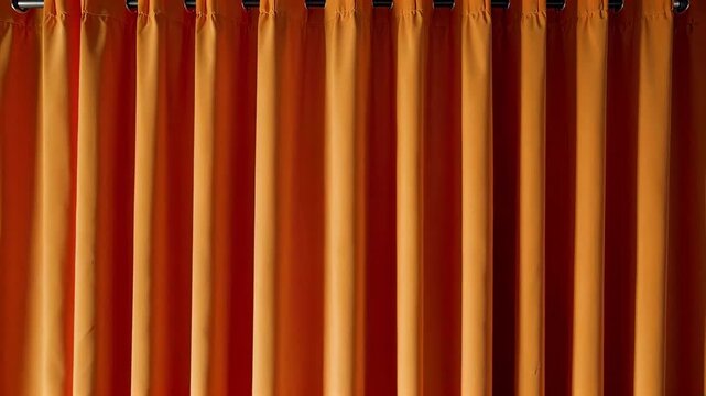 Close-up of orange-red pleated curtains