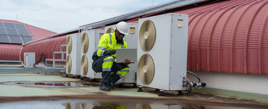 Technicians are inspecting the air conditioning and refrigeration systems in a commercial building.