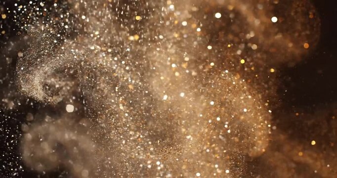 Glittering gold particles floating freely.