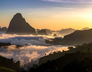 Obraz premium A serene mountain landscape at sunrise with misty clouds