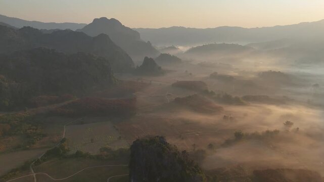 An aerial view of the forest and mountains in a misty morning at Pha Chai Noi, Thailand.
