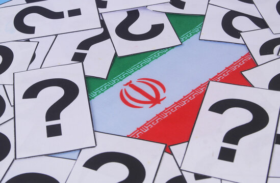Flag of Iran with many question marks close up.