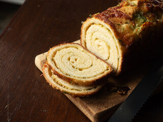 slice of garlic bread loaf on wooden board